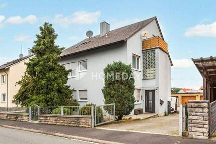 Vielseitiges Einfamilienhaus mit zwei Wohneinheiten, Garagen und Nebengebäude in ruhiger Lage 1 zimmer